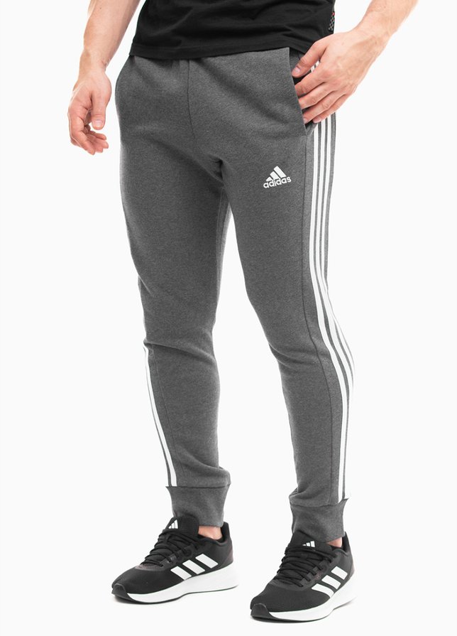 adidas Pánske tepláky Essentials French Terry Tapered Cuff 3-Stripes IC9408 adidas Pánske tepláky Essentials French Terry Tapered Cuff 3-Stripes IC9408